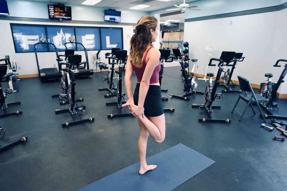 Woman demonstrating the standing quadriceps stretch exercise