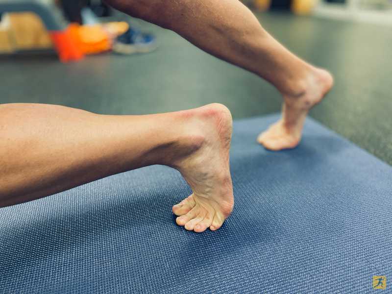 Man stretching his ankle and foot