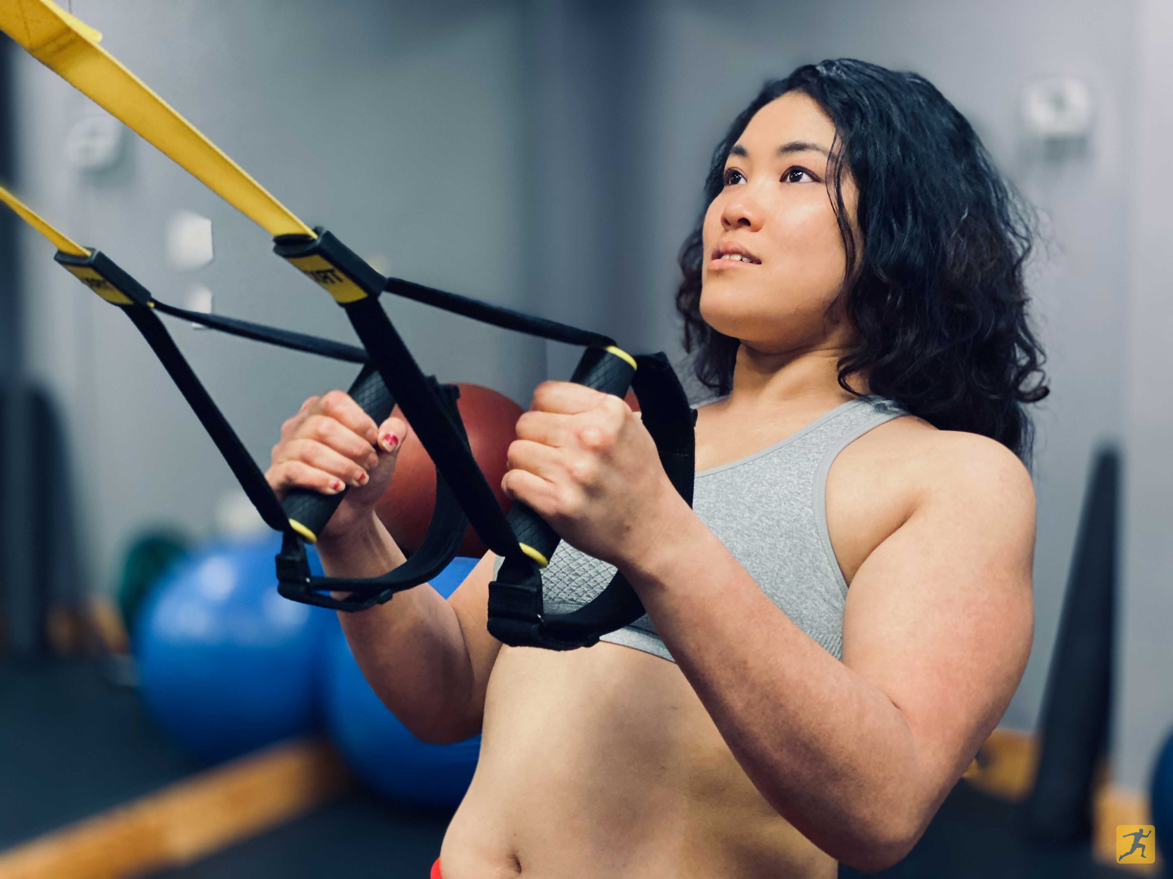 Woman doing TRX rows