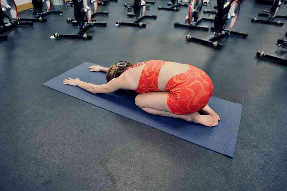 Woman demonstrating child's pose exercise