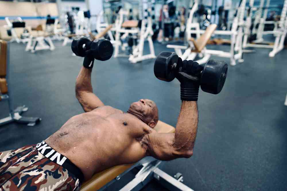 Man doing bench press using dumbells