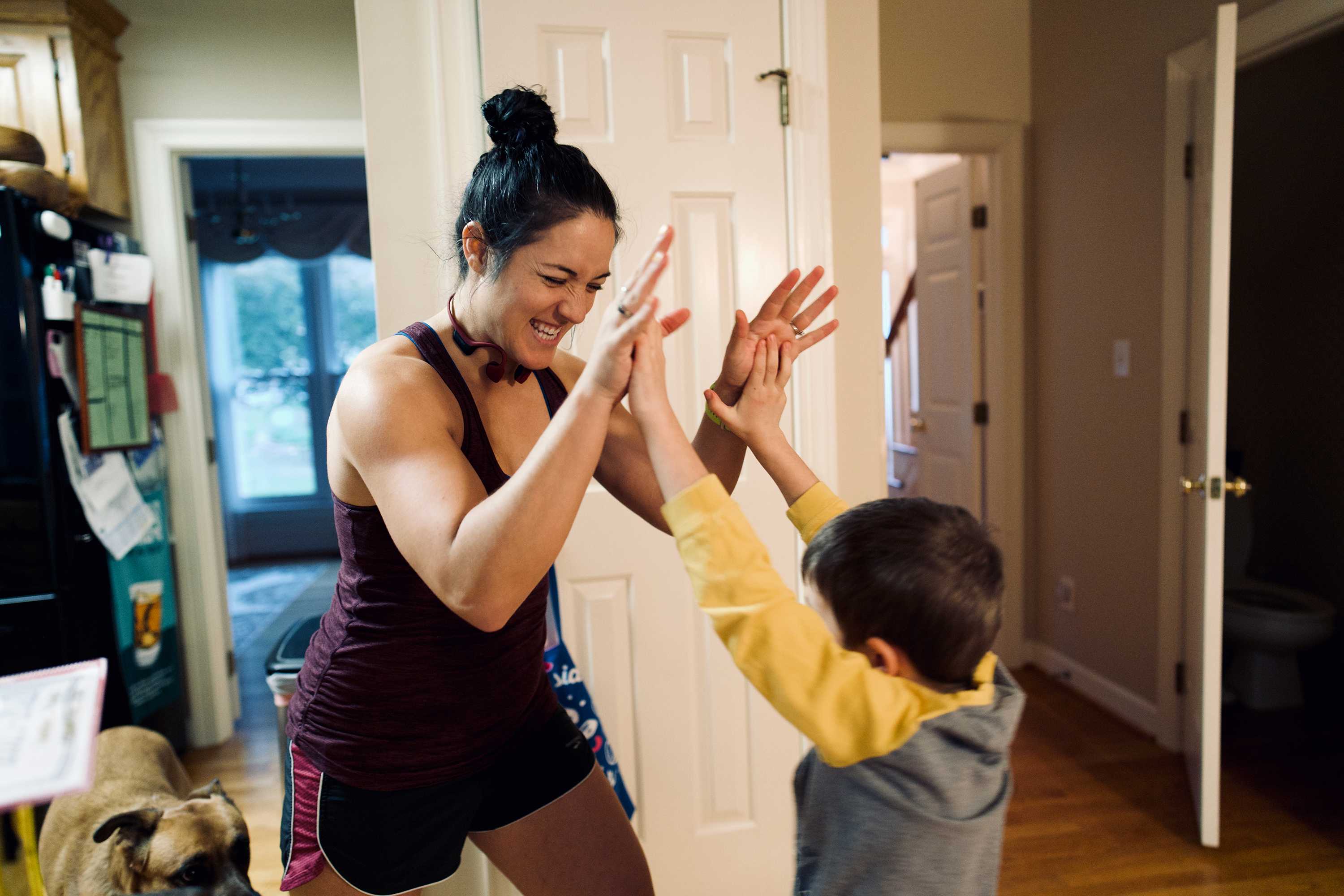 Mother giving high fives to her son