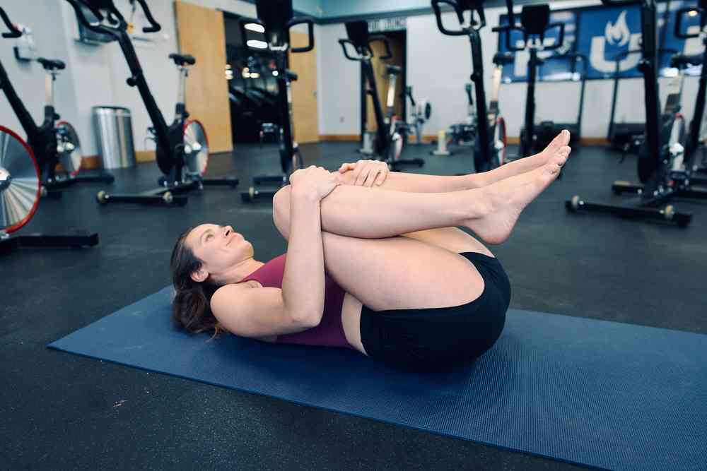 Woman demonstrating the double knee-to-chest exercise