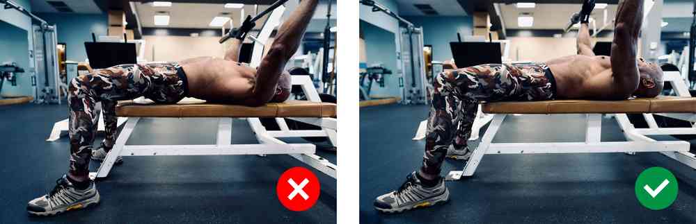 Try to keep the bar directly over your chest vertically and keep your feet flat on the floor when doing bench press. Photos that show a flat back on the bench vs arched back