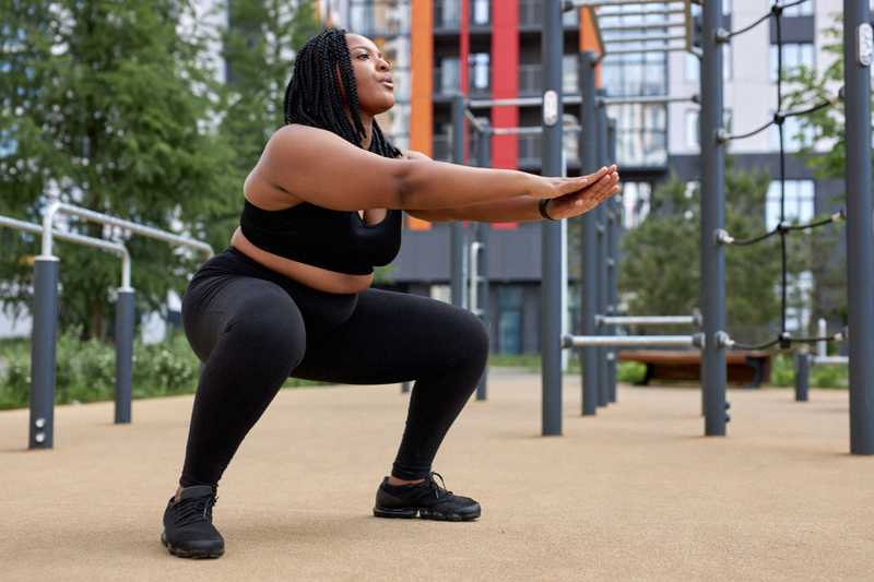 Postpartum woman doing squats