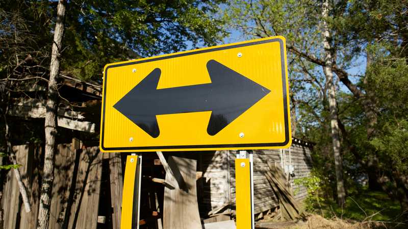 Street sign with arrows in both directions