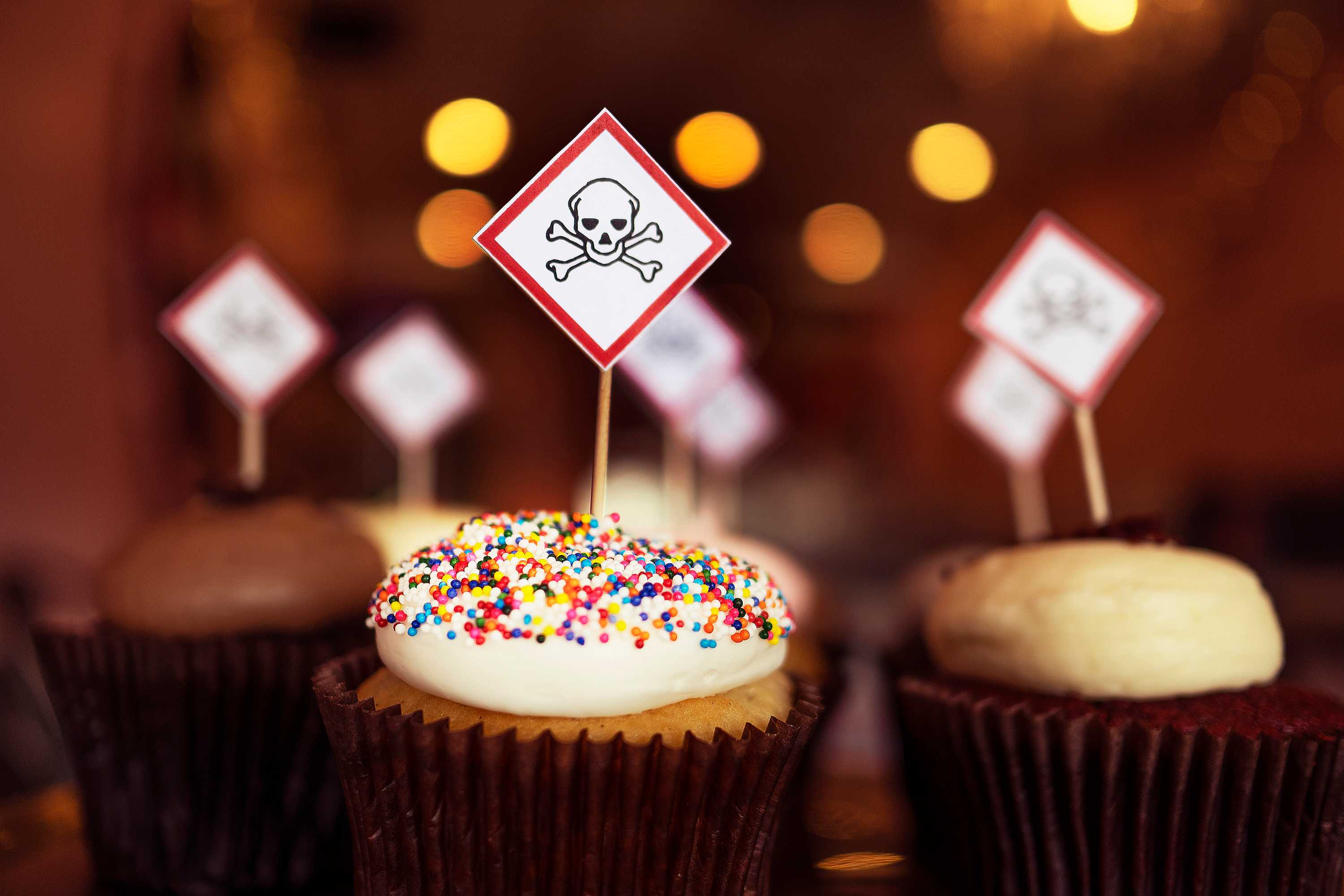 Cupcakes and toppers with poison symbols on them. Avoid frequent deserts like cupcakes to reduce high blood sugar.