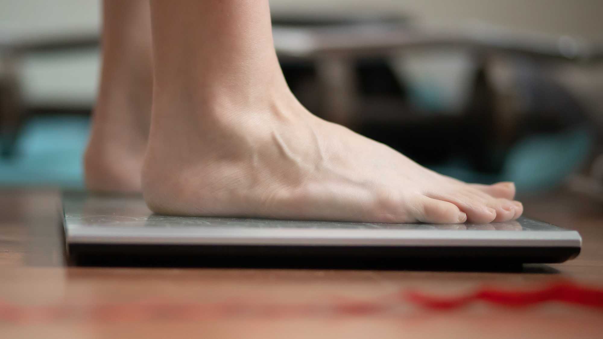 Woman weighing herself