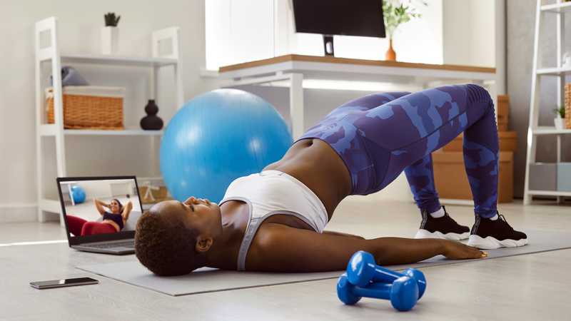 Woman doing pelvic therapy exercise at home