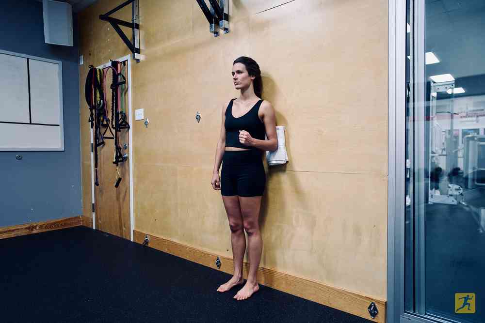 Woman performing an isometric shoulder extension exercise