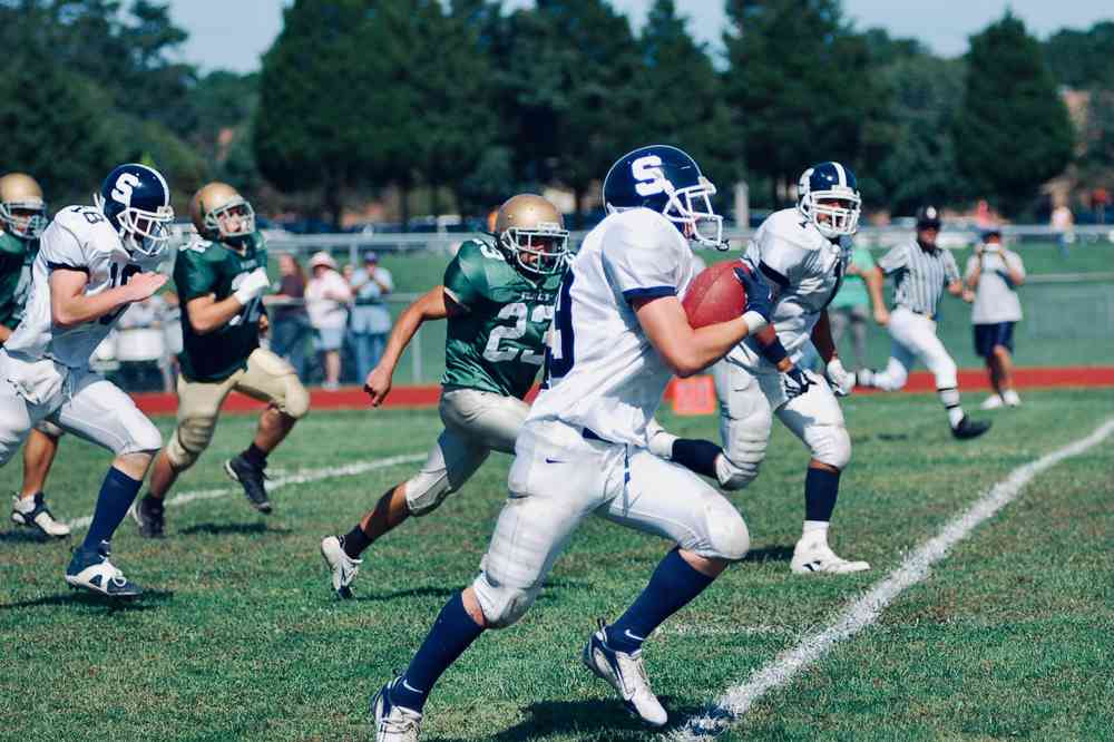 High school football players during game