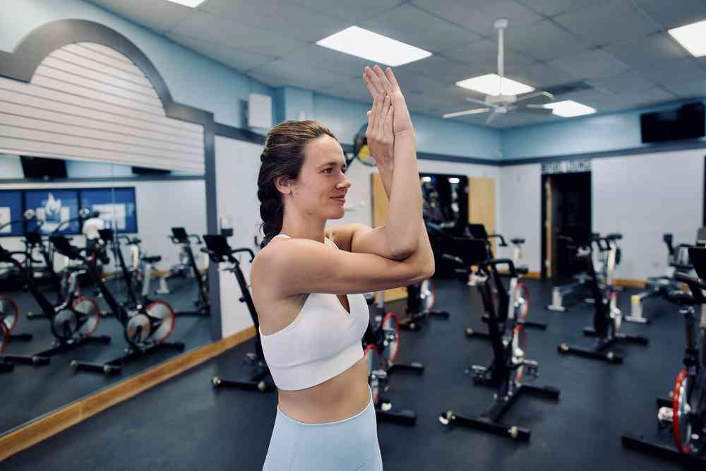 Woman demonstrating eagle arms exercise